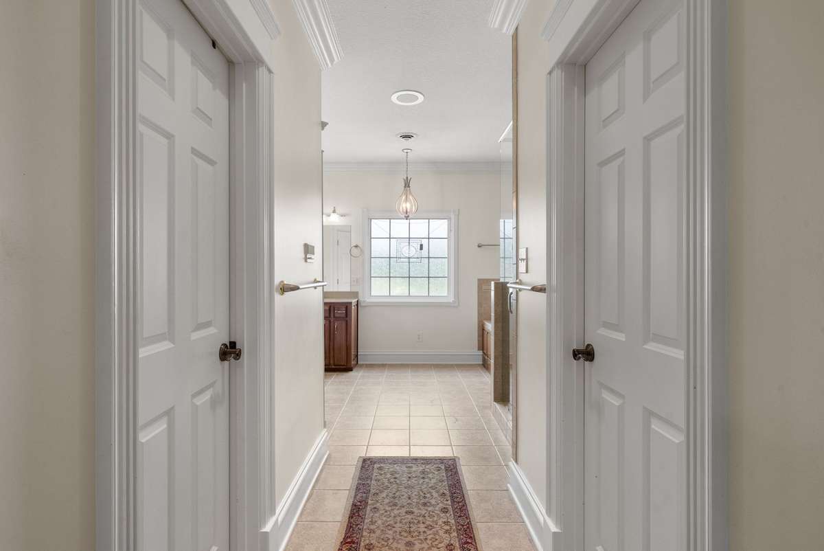 Primary Bathroom with walk-in closets on either side