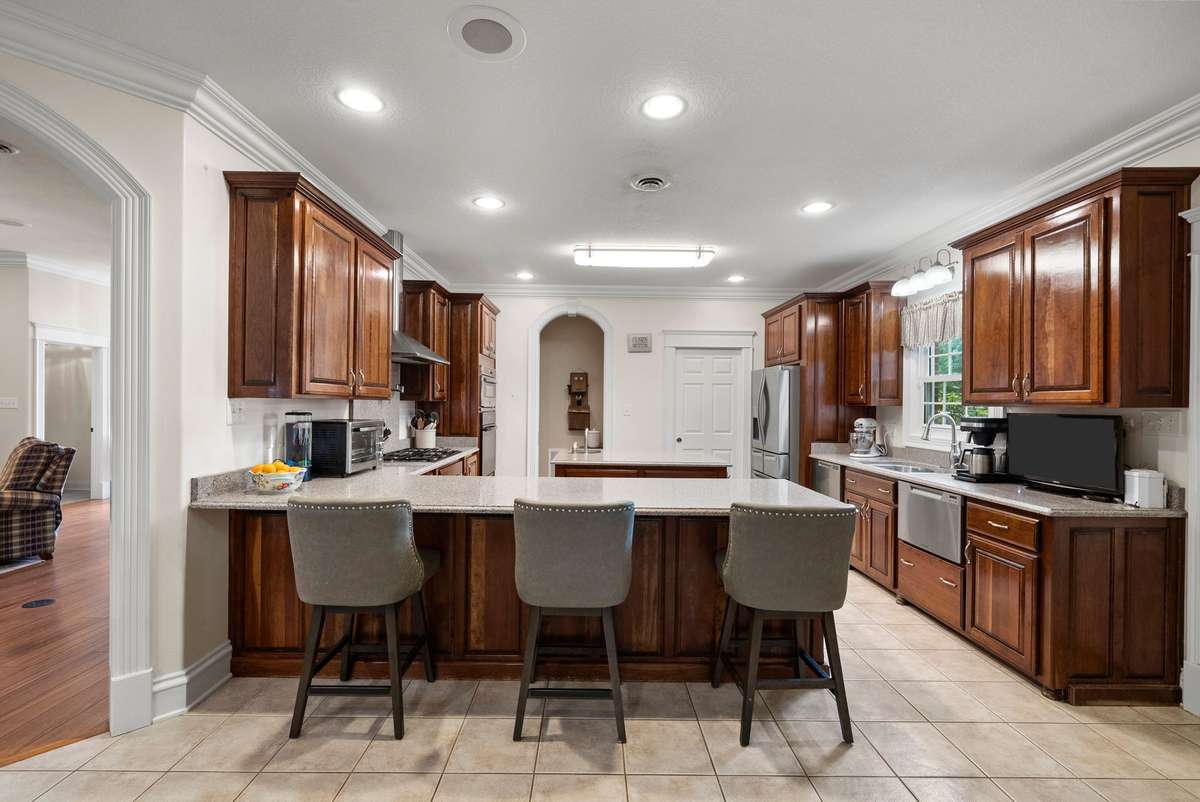 Huge kitchen with custom cabinets, spacious granite countertops, 2 (yes 2!) dishwashers, trash compactor, gas stove, built-in oven, 2 compartment sink, AND an island sink