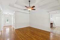 Living room looking toward the entry door and the kitchen/eat-in dining to the right.