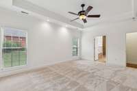 Primary bedroom entry is in the short hallway off the living room and front entry to the home.