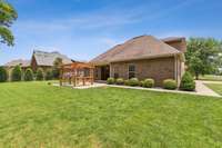 View looking back at the west side of the house.  Mature landscaping, well maintained.