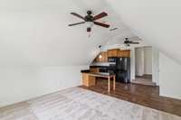 Second floor bonus room looking back toward the kitchen.