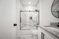 GORGEOUS, custom tiled bathtub/shower in the guest bathroom.