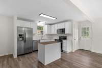 Kitchen Features New Cabinets, Island with Butcher Block Top, Faucets, Sinks, Granite Countertop, Smart Lights, LVP Flooring, Microwave 2025, Refrigerator-Dishwasher-Range 2023