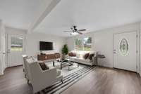 Living Room with Plenty of Space for Family! Photo is only 1 example of how furniture will easily fit in this area. A U-Shaped Sectional with the TV mounted on the wall located beside the front door would be my preference for sure!