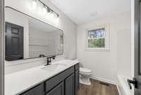 Hall Bath with New Vanity, Granite Countertop, Faucet, Light, Mirror & Toilet, Window Replaced 2011. Check out the faucet, super cool!
