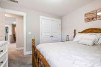 Bedroom with neutral tones, carpet flooring, and a spacious closet—comfortable and move-in ready.