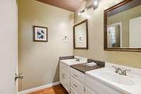 Hall bath with 2 double vanity separate from bath area.