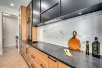 Sleek and modern flush mount induction cooktop and custom low profile range hood.