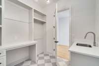 Large laundry room with built-ins and sink.