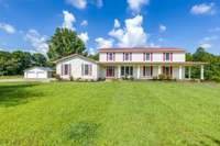 Wraparound front porch and four car garage; That is just the beginning of what his home has to offer.