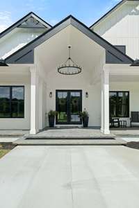 Inviting front porch with large windows, allowing plenty of natural light.