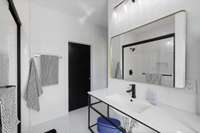 En suite of bedroom 2 connects to walk-in closet.   Closet has solid shelving system installed.