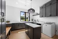 Actually enjoy doing laundry! Sunlight galore, sink to pre-wash, cabinets to store, island to fold, and bench to rest!