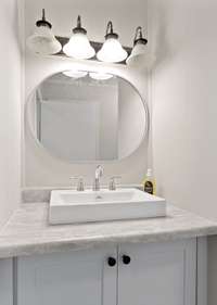 The bathroom has new plumbing, vanity, and lights.