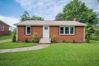 The front yard has new landscaping, new shutters, and the porches have been painted.