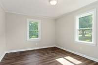 The front bedroom also has new flooring, paint, and a light fixture.