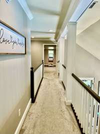 View of upstairs hallway! Shows how open this house is and leads to the Rec Room and bedrooms