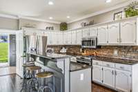 The kitchen has a eat in bar