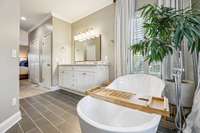 The stand alone tub and new gray stone tiles are just perfect for this space