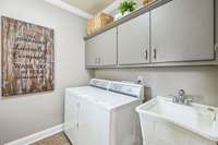 The Utility Room has cabinets, shelving and a beautiful wood folding table
