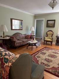 Living room showing door to front entry area