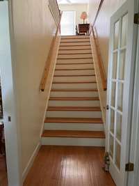 Extra wide stairs leading to upstairs hall