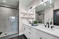 Double Vanities in Primary Bath  with Custom Cabinets and Shelving.