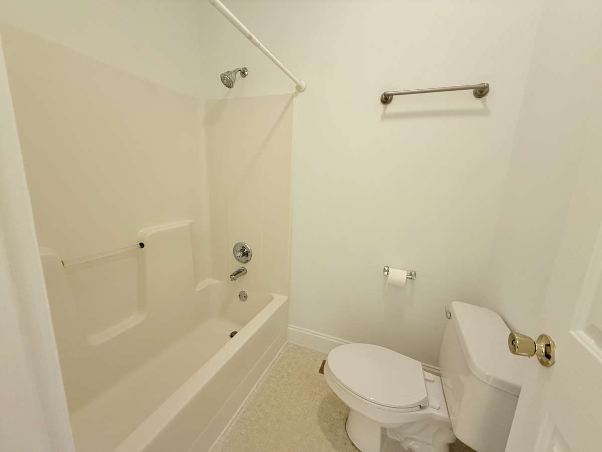 Combo shower tub in primary bedroom
