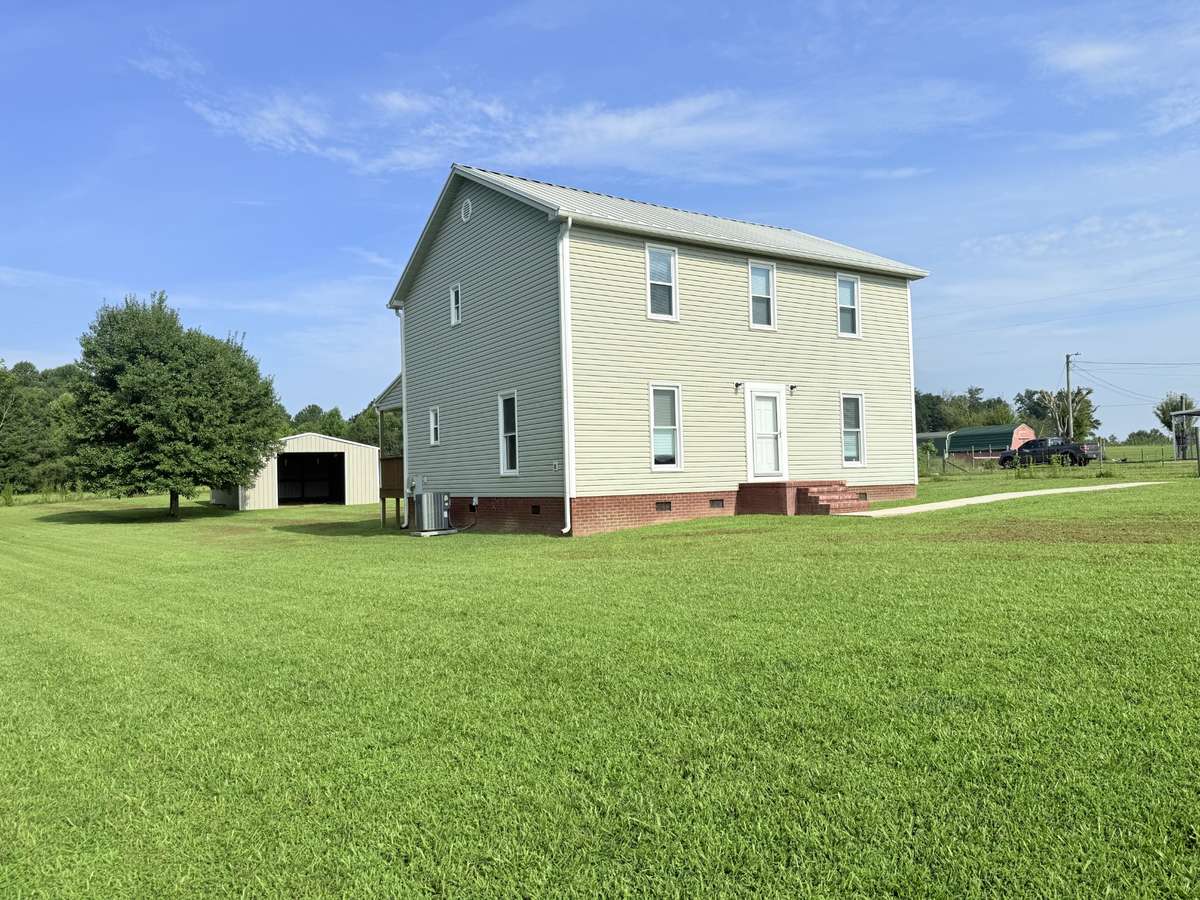 View of 4 bedroom and 2 bath home and metal building!