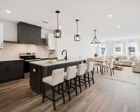 Virtually staged.  Open kitchen, dining, and living room.