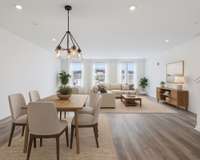 Virtually Staged.  Looking from kitchen into the dining and living areas.