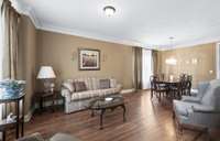 The bright, formal Living Room offers the warm, earthy colors and the beautiful hardwoods found throughout the home.