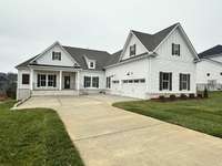 The Rutledge Farmhouse in all white! 3 car garage, big front porch and lots of extra parking.