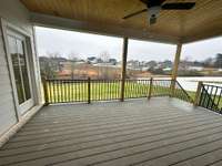 Large covered porch leading to spacious back yard.