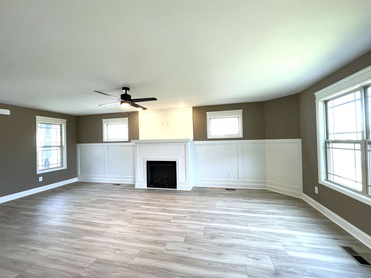 Great Room is Highlighted with Electric Fireplace, Custom Trim & Paint & Lots of Windows for Natural Lighting....