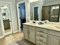 Primary Full Bath Room With High Double Vanities.