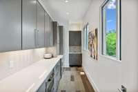 Amazing scullery room to house all your appliances, storage and entertaining needs. Crazy! Look at the tree views from this room too.