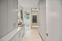 Two separate full primary baths with walls of meticulous custom closetry. 
Bath 1 of 2.