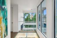 View of sunset tower chandelier and beautiful translucent floor that looks down into the foyer.