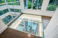 View from the lighted translucent 2nd floor area down to the foyer/front doors.