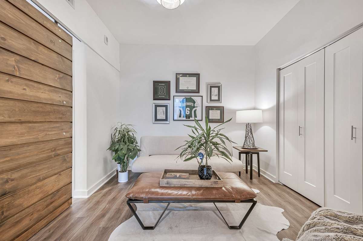 This room is currently used as a home office and guest room. It has a large closet and with the barn door, it can serve as a secondary bedroom.