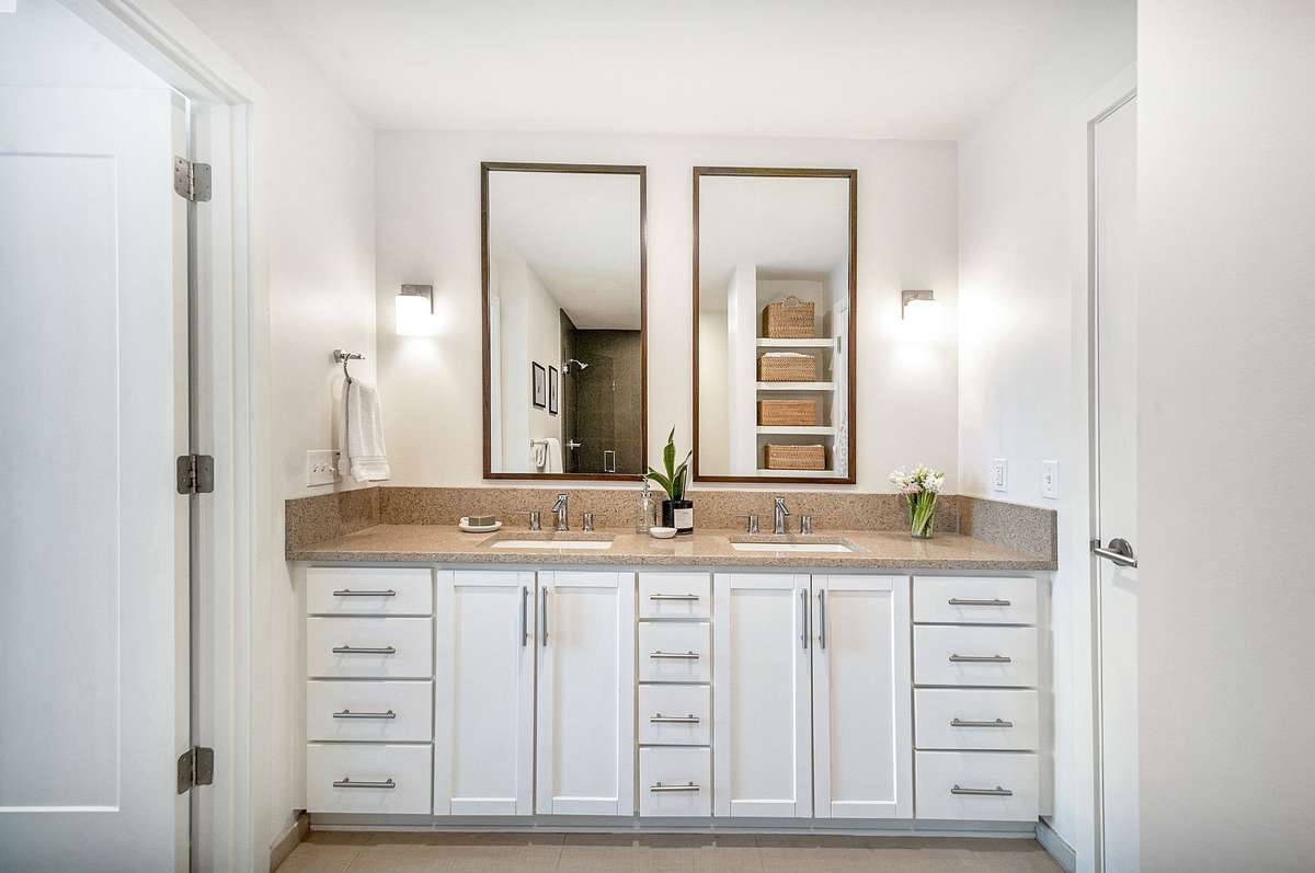 The bathroom is accessed through a door from the primary bedroom and the other door is to the flex room.