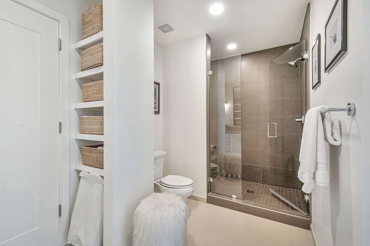 oversized walk-in shower and built-in storage in the bathroom