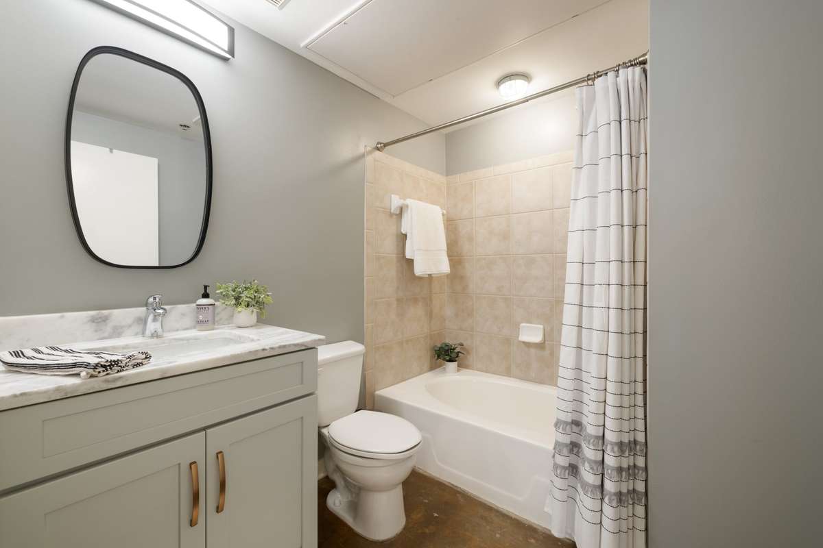 Large second full bath. Beautiful quartz, custom vanity & mirror.