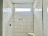 Your shower and glossy large subway tiles.
