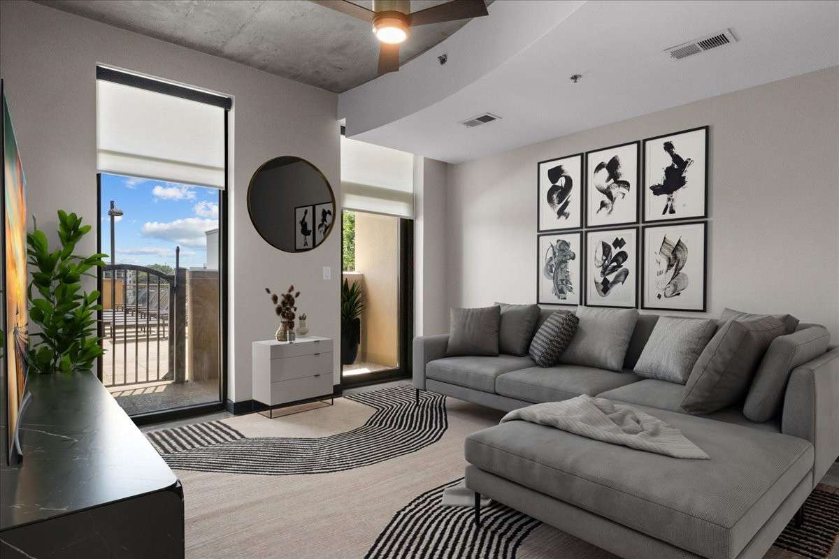 Virtually staged Living Room area. Large floor-to-ceiling windows throughout the unit, and all have custom remote blinds