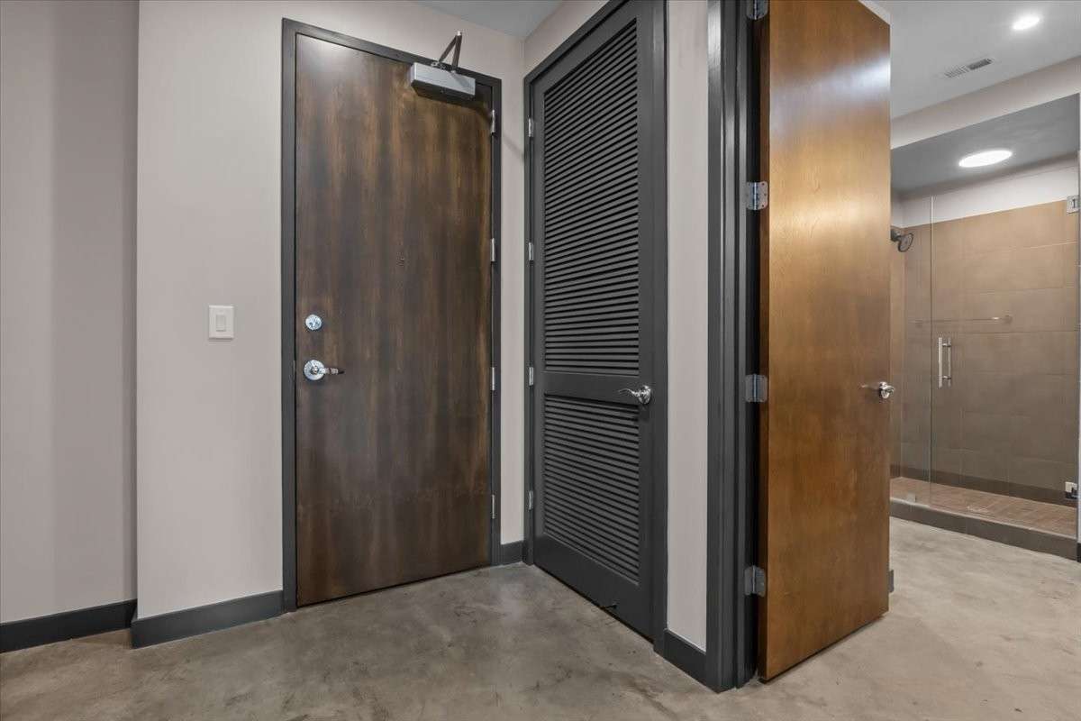 Main entry door to the unit. Behind the lovered door is the water heater for the unit.