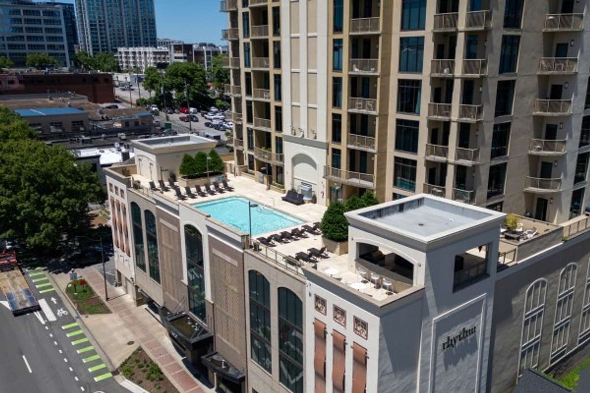 Aerial view of the building showcasing the pool and entertainment area on the 5th floor.