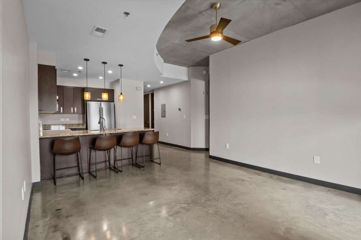 An open Kitchen and bar area. Four barstools come with the unit.